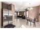 View of kitchen that opens to the living room with plush sofa at 2580 E Boston St, Gilbert, AZ 85295