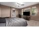 Main bedroom with ceiling fan, windows, tv and ensuite bathroom at 2580 E Boston St, Gilbert, AZ 85295
