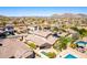 Stunning aerial view of desert community featuring a sparkling pool, covered patio, and mountain views at 26015 N 85Th Dr, Peoria, AZ 85383