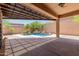 Expansive covered patio overlooks the backyard featuring a swimming pool and desert landscaping at 26015 N 85Th Dr, Peoria, AZ 85383