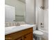A clean, well-lit bathroom features a white sink, tiled backsplash, and shower-tub combination at 26015 N 85Th Dr, Peoria, AZ 85383