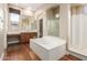 Luxurious bathroom with a soaking tub, separate shower, and vanity area, ideal for relaxation and comfort at 26015 N 85Th Dr, Peoria, AZ 85383
