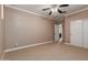 Bedroom with a closet, a ceiling fan, and neutral carpeting and walls at 26015 N 85Th Dr, Peoria, AZ 85383