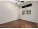 Neutral bedroom with wood-look floors features a ceiling fan and window with blinds at 26015 N 85Th Dr, Peoria, AZ 85383