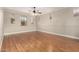 An expansive main bedroom with a ceiling fan, hardwood floors and multiple windows at 26015 N 85Th Dr, Peoria, AZ 85383