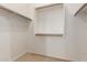 Walk-in closet with installed shelving providing ample storage for clothes and accessories at 26015 N 85Th Dr, Peoria, AZ 85383