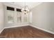 Dining room with wood-look floors, chandelier, window with blinds and shutters at 26015 N 85Th Dr, Peoria, AZ 85383