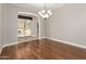 Dining room with wood-look floors, chandelier, and a view of the patio and backyard at 26015 N 85Th Dr, Peoria, AZ 85383