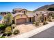 Stunning home featuring a tile roof, desert landscaping, and a spacious driveway leading to a two-car garage at 26015 N 85Th Dr, Peoria, AZ 85383