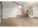 Spacious garage with built in storage cabinets and open garage door at 26015 N 85Th Dr, Peoria, AZ 85383