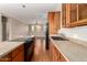 Kitchen with black appliances, ample cabinets, and an inviting peninsula with bar seating at 26015 N 85Th Dr, Peoria, AZ 85383