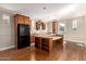 Kitchen with bar seating, sleek black appliances and light-filled cabinets and countertops at 26015 N 85Th Dr, Peoria, AZ 85383