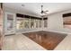 Open concept living room features wood-look floors, tiled floors, and backyard access at 26015 N 85Th Dr, Peoria, AZ 85383