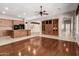 Open concept living room and kitchen features wood-look floors and wood cabinets at 26015 N 85Th Dr, Peoria, AZ 85383
