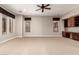Bright living room with multiple windows, neutral paint, and soft carpeting for a comfortable atmosphere at 26015 N 85Th Dr, Peoria, AZ 85383