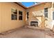 A cozy outdoor living space with stone fireplace and brick patio, perfect for relaxing evenings at 26015 N 85Th Dr, Peoria, AZ 85383