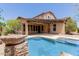 Beautiful backyard pool with covered patio and lush landscaping for outdoor enjoyment at 26015 N 85Th Dr, Peoria, AZ 85383