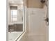 Modern shower and tub combination with glass partition, showcasing contemporary bathroom design and fixtures at 26015 N 85Th Dr, Peoria, AZ 85383