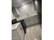 Well-lit kitchen with gray cabinets, granite countertops, black appliances, and modern fixtures at 2662 N 43Rd Ave # B, Phoenix, AZ 85009