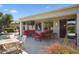 Inviting covered patio with red cushioned seating, perfect for outdoor relaxation and entertaining at 26840 W Irma Ln, Buckeye, AZ 85396