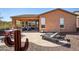Spacious backyard featuring a travertine patio with outdoor seating, lounge chairs, and desert landscaping at 28351 N 130Th Dr, Peoria, AZ 85383