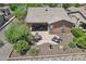 Aerial view of a backyard featuring an outdoor dining area, lounge chairs, covered patio, and desert landscaping at 28351 N 130Th Dr, Peoria, AZ 85383
