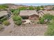 A beautiful backyard featuring a covered patio, outdoor dining area, lounge chairs, and desert landscaping at 28351 N 130Th Dr, Peoria, AZ 85383