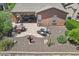 Aerial view of a backyard showcasing a covered patio, outdoor seating, lounge chairs, and beautiful desert landscaping at 28351 N 130Th Dr, Peoria, AZ 85383
