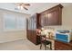 Bedroom featuring a Murphy bed, built-in shelving, a desk, and a ceiling fan at 28351 N 130Th Dr, Peoria, AZ 85383