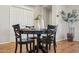Cozy dining area featuring a round dark wood table with four chairs and a decorative plant at 28351 N 130Th Dr, Peoria, AZ 85383