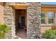 Inviting entryway with stone accents and tile flooring, showcasing the home's architectural details at 28351 N 130Th Dr, Peoria, AZ 85383