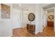 Bright foyer with hardwood floors and stylish accents creating an inviting and modern entrance at 28351 N 130Th Dr, Peoria, AZ 85383
