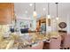 Gourmet kitchen with granite countertops, wood cabinets, a central island, and modern stainless steel appliances at 28351 N 130Th Dr, Peoria, AZ 85383