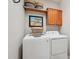Laundry room featuring a front load washer and dryer with upper cabinets at 28351 N 130Th Dr, Peoria, AZ 85383