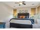 Inviting main bedroom with a dark wood bed frame, soft carpet, and a ceiling fan at 28351 N 130Th Dr, Peoria, AZ 85383