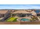 Aerial view of a home with a pool, putting green, and landscaped backyard in a serene community at 3529 N Boulder Canyon St, Mesa, AZ 85207
