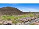Scenic aerial view of a golf course community nestled near the mountains, showcasing beautiful homes and landscape at 3529 N Boulder Canyon St, Mesa, AZ 85207