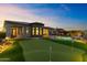 Beautifully landscaped backyard with putting green, pool, and inviting patio at 3529 N Boulder Canyon St, Mesa, AZ 85207
