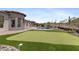 Backyard featuring putting green, pool, and desert landscaping at 3529 N Boulder Canyon St, Mesa, AZ 85207