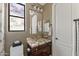 Elegant powder room with custom vanity, granite countertop, and decorative mirror, blending style with functionality at 3529 N Boulder Canyon St, Mesa, AZ 85207