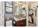 Charming bathroom with a decorative mirror, unique stained-glass window, and a closet space at 3529 N Boulder Canyon St, Mesa, AZ 85207