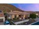 Desert home at dusk features stone accents, lush landscaping, and mountain views at 3529 N Boulder Canyon St, Mesa, AZ 85207