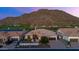 Stunning single-story home featuring desert landscaping, brick driveway and tile roof against a mountain backdrop at 3529 N Boulder Canyon St, Mesa, AZ 85207