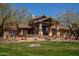 Expansive home featuring grand windows, a tile roof, desert landscaping, and a secure fence at 3529 N Boulder Canyon St, Mesa, AZ 85207