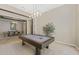 Spacious game room featuring a pool table, decorative lighting, and adjacent dining area for entertaining guests at 3529 N Boulder Canyon St, Mesa, AZ 85207