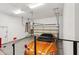Spacious three-car garage with epoxy flooring, overhead storage, and a vibrant orange sports car at 3529 N Boulder Canyon St, Mesa, AZ 85207