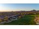 Picturesque view of a golf course and desert landscape at dusk, surrounded by luxury homes at 3529 N Boulder Canyon St, Mesa, AZ 85207