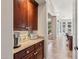 Hallway view shows dark cabinetry, tan countertops and view into the home at 3529 N Boulder Canyon St, Mesa, AZ 85207