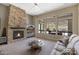 Inviting living room with stone fireplace and views of the pool area at 3529 N Boulder Canyon St, Mesa, AZ 85207