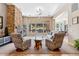 Spacious living room featuring a stone fireplace, ample seating, and large windows with golf course views at 3529 N Boulder Canyon St, Mesa, AZ 85207